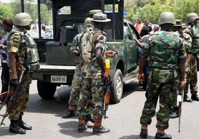 Nigerian soldiers arrest female bandit dancing with AK-47 rifle